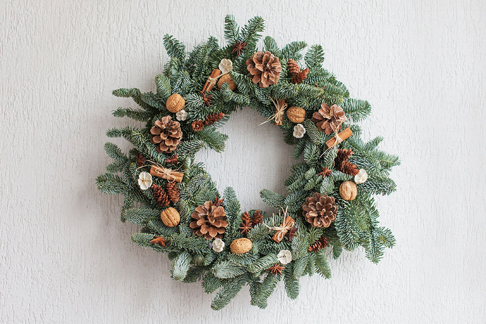 Fir wreath hanging on a while wall